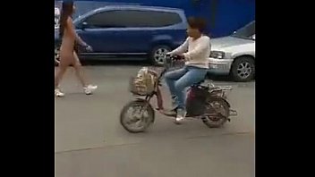 china women walks nude on road.
